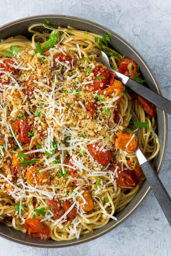 Pasta tossed with pan roasted tomatoes and topped with toasted bread crumbs and parm cheese