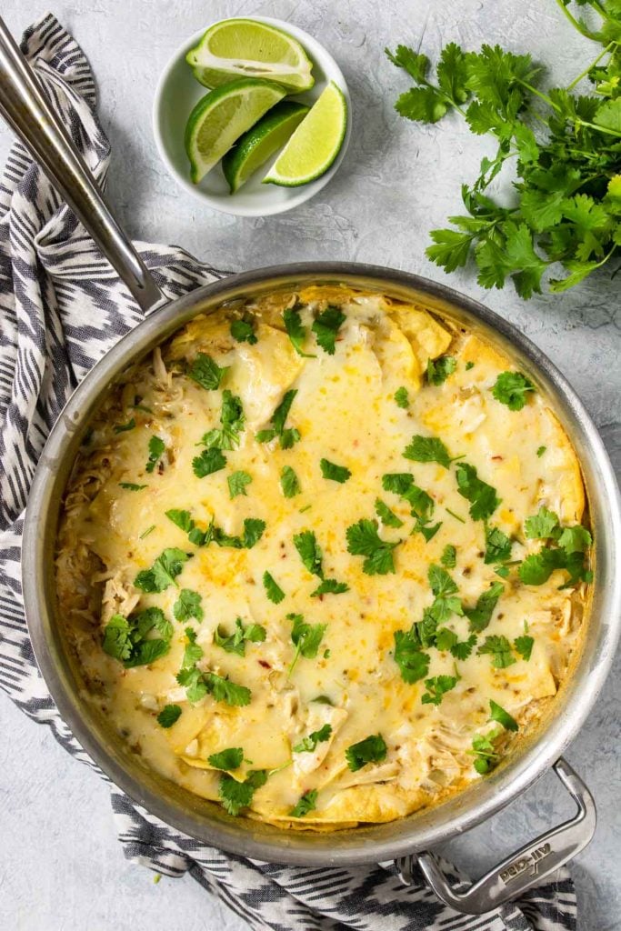 White Chicken Enchilada Casserole in a skillet topped with cilantro