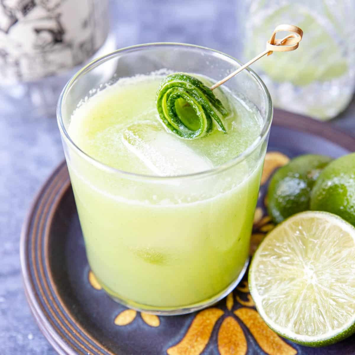 Cucumber margarita in a glass with a cucumber rosette garnish