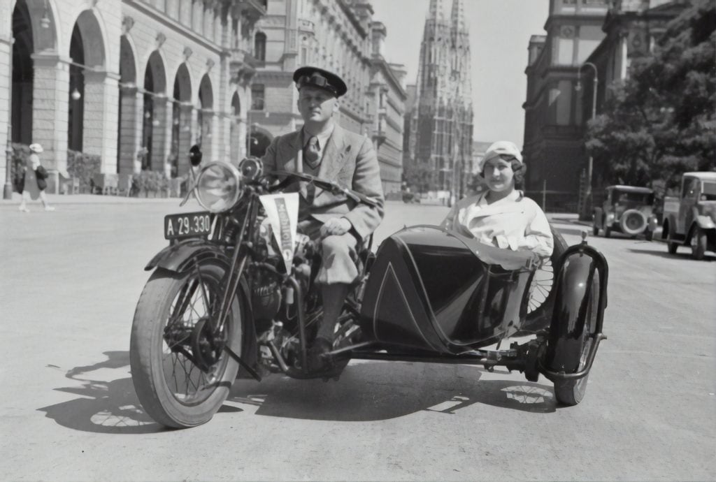 a black and white old photo of a motorcycle with a side car
