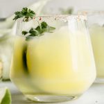 sweet corn margarita in a glass with cilantro