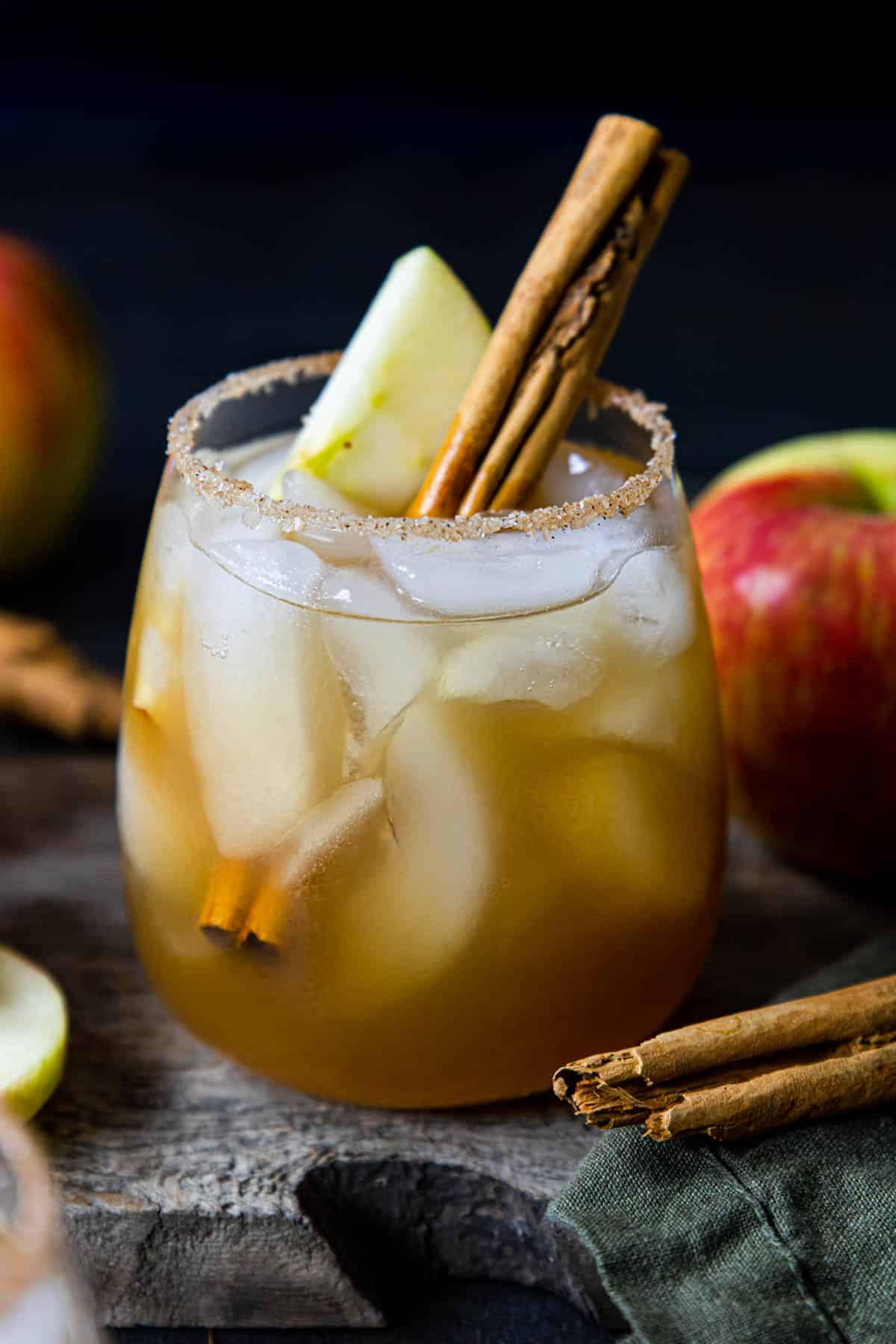 a table with apple cider margaritas with cinnamon sugar rims and apple cinnamon stick garnish