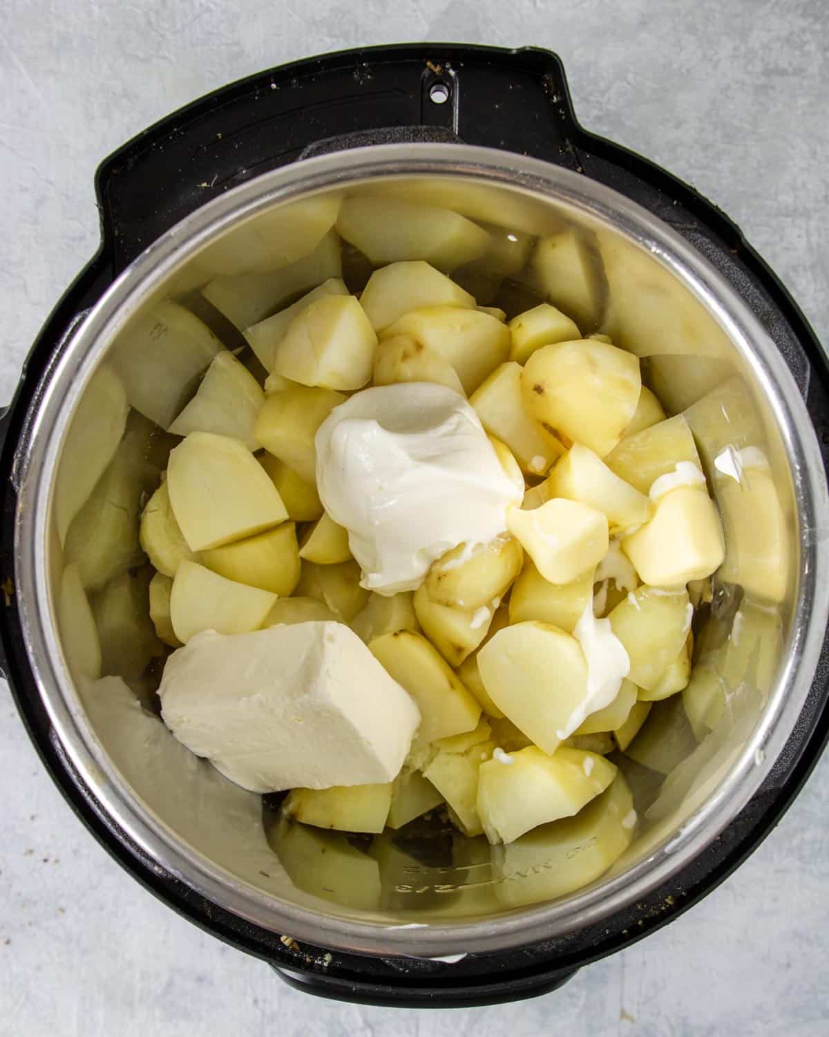 cooked russet potatoes in the instant pot with cream cheese, sour cream and butter