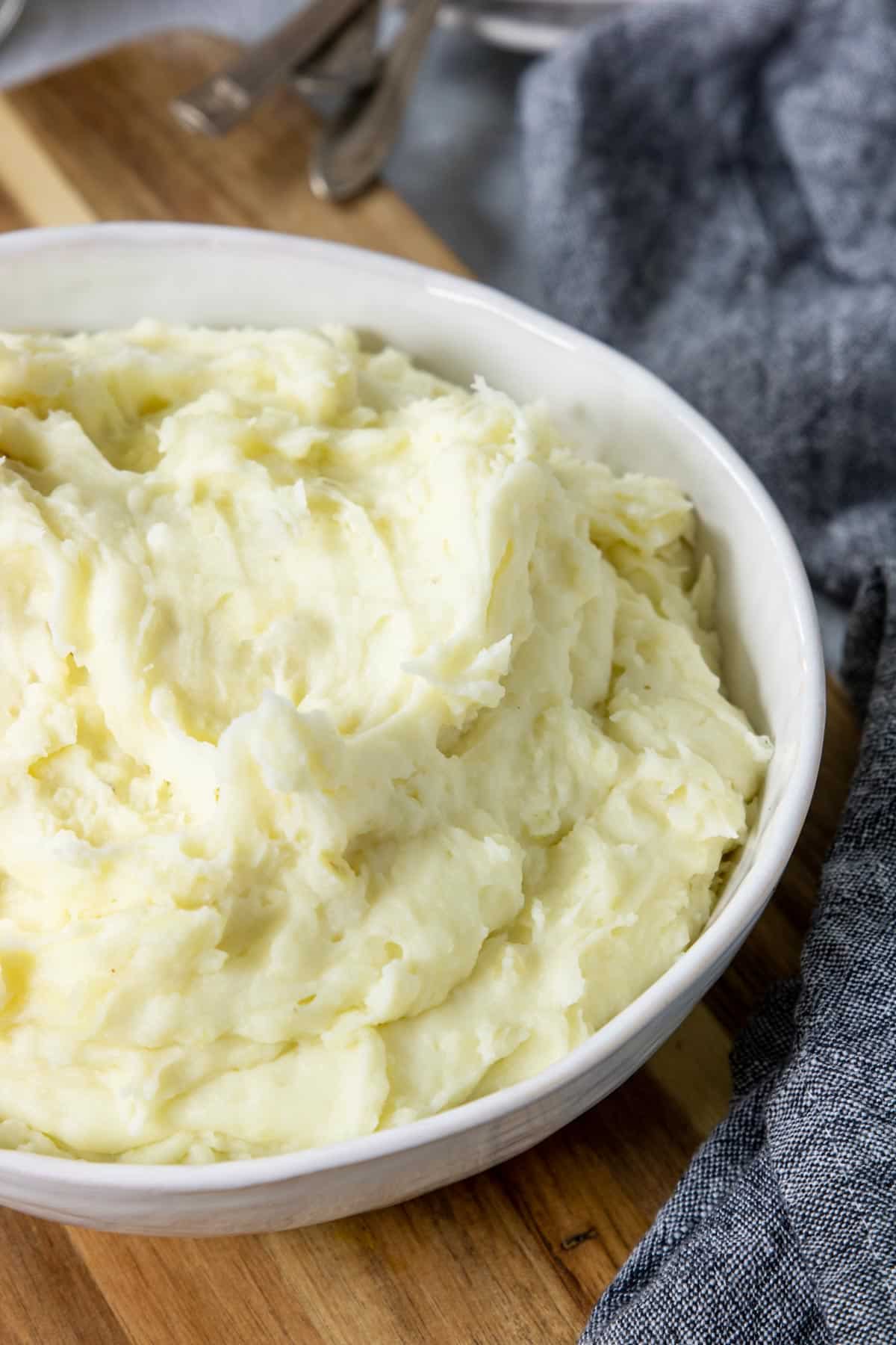 a bowl of creamy Instant Pot Mashed Potatoes on a table