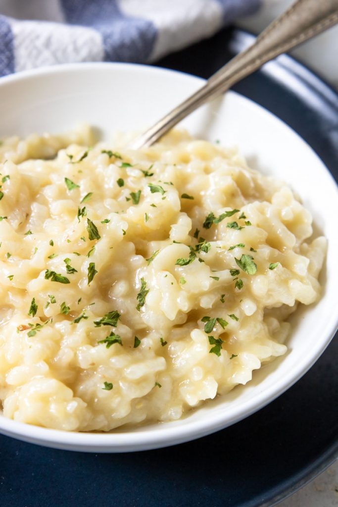 a bowl of creamy risotto garnished with parsley