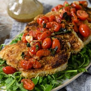 pork milanese topped with a tomato relish