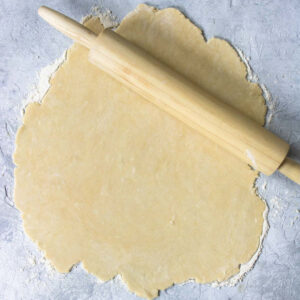 Vodka Pie Crust Dough rolled out on a surface with flour