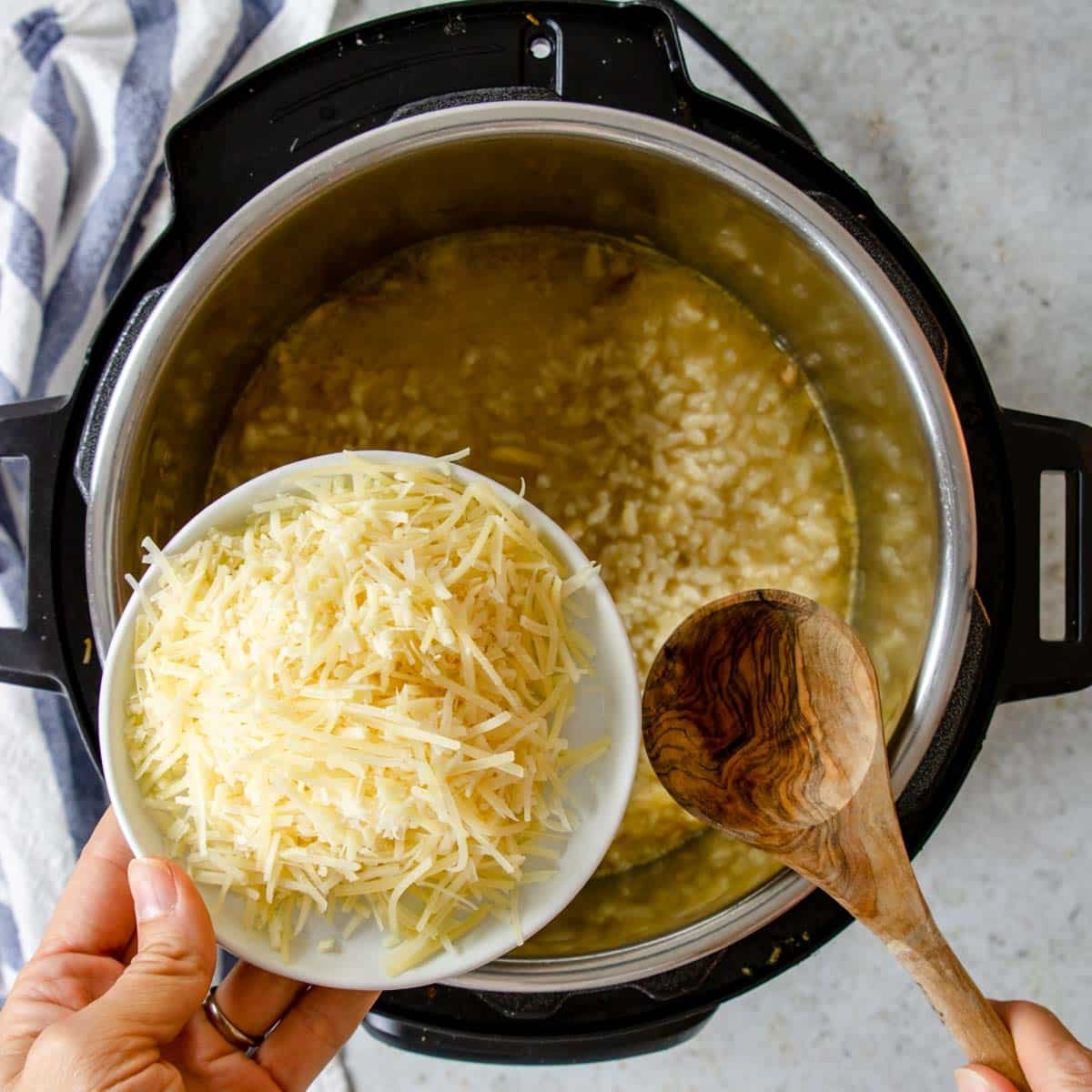 adding parmesan to the risotto