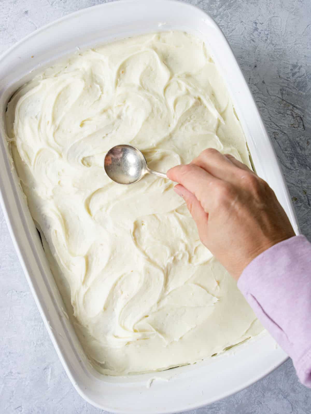 making swoops in frosting with the back of a spoon