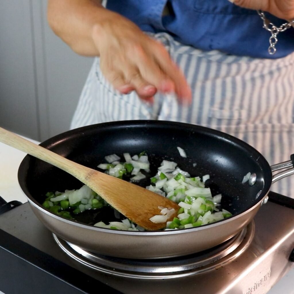 sauteeing onions, garlic and jalapeno in a skillet 
