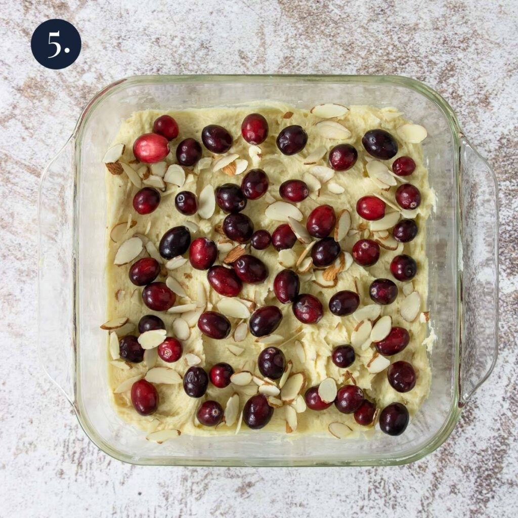 cranberries and sliced almonds on top of cake batter