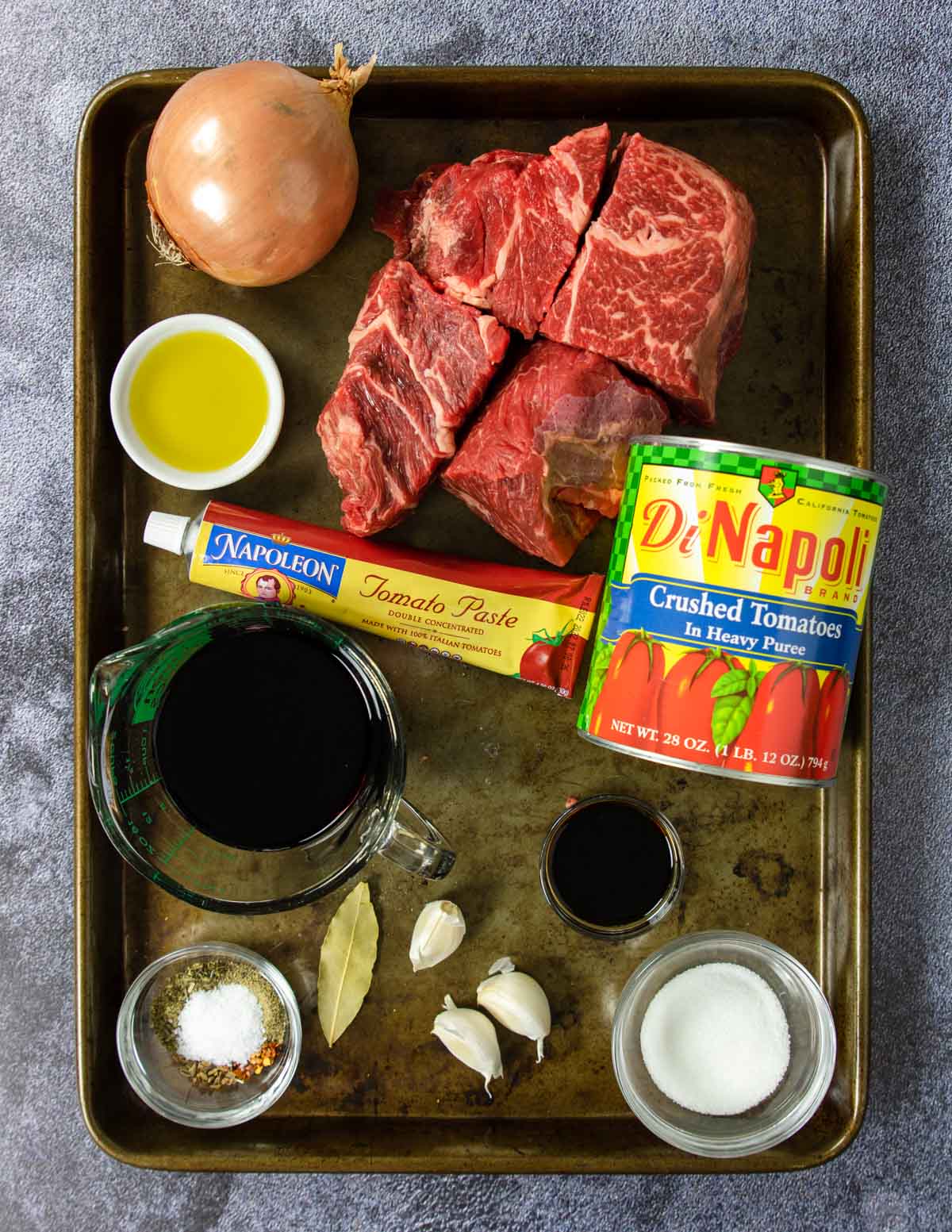 Ingredients for beef ragu on a sheet pan