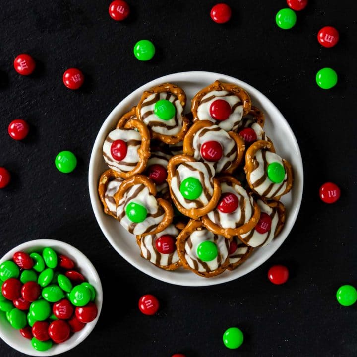 christmas hug cookies on a black slate background with holiday M&M's scattered