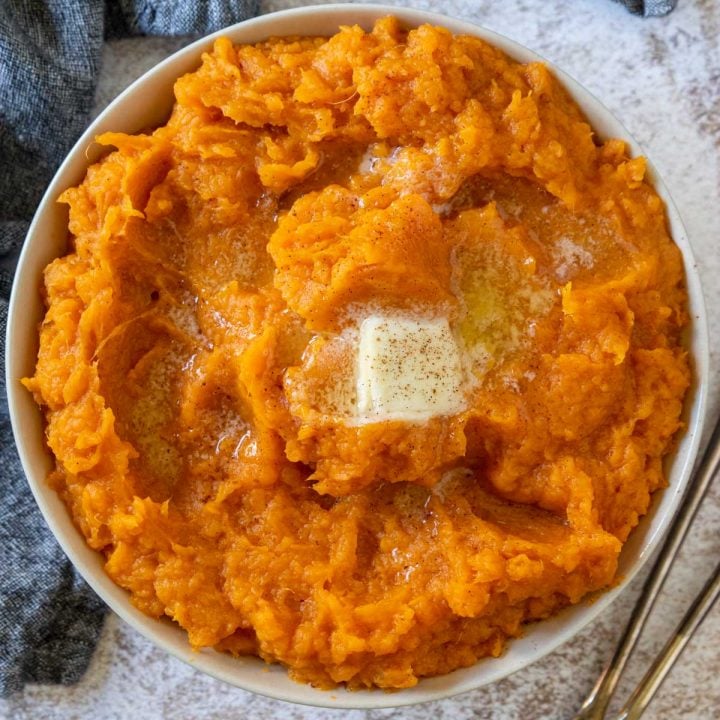 mashed sweet potatoes topped with butter and cinnamon sprinkled on top