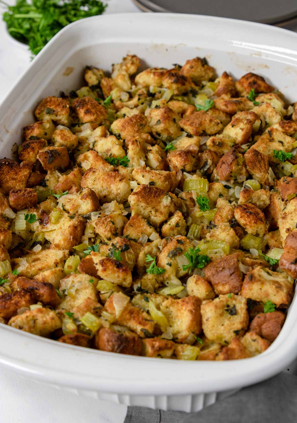traditional stuffing in a white casserole pan