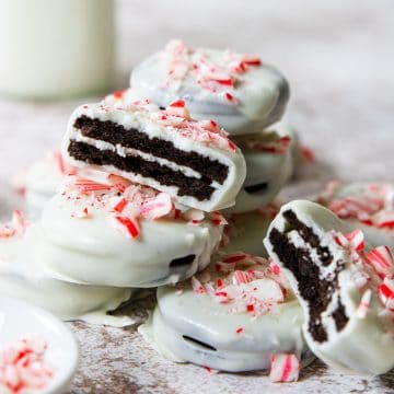 peppermint bark oreos in a pile with a bite taken out of two cookies
