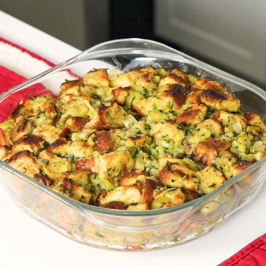 a pan of baked holiday stuffing on the counter 