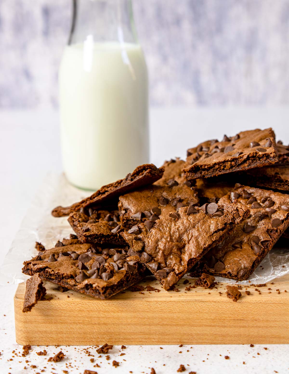 brownie brittle on a cutting board with a bottle of milk