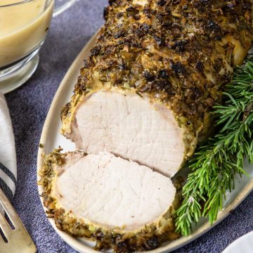 a sliced pork loin topped with garlic and herbs