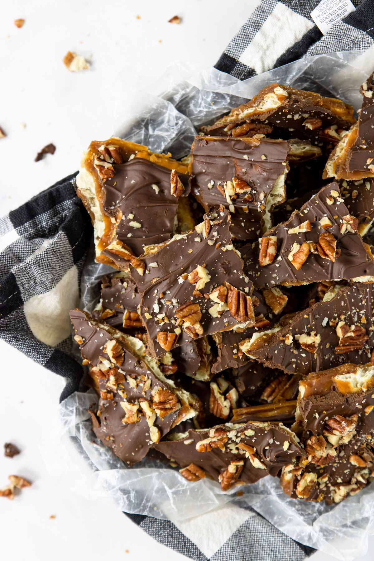 Saltine Toffee (Christmas Crack) in a bowl with a black and white napkin
