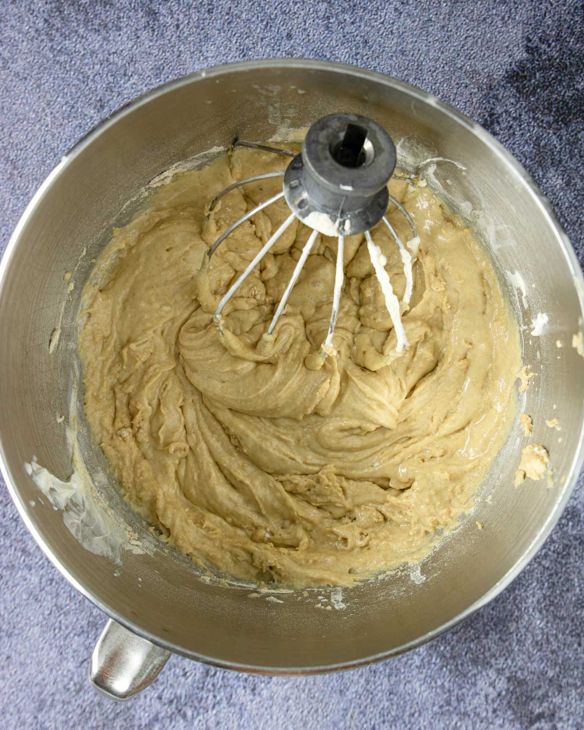 sour cream muffin batter in a mixing bowl with a whisk attachment