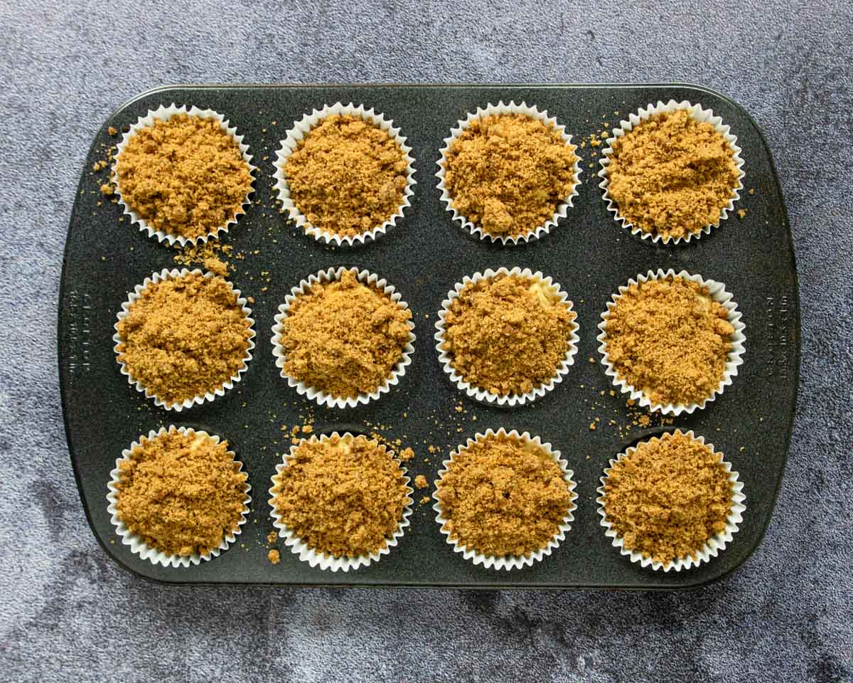 a muffin tin full of unbaked coffee cake muffins