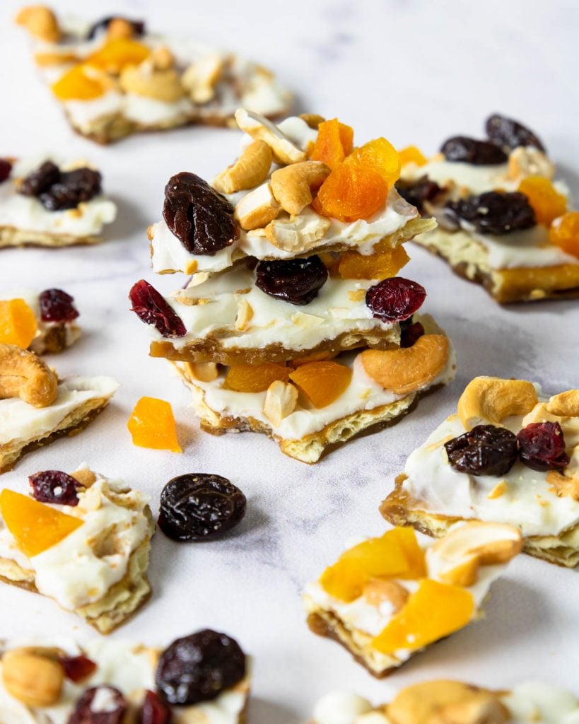 a pile of white chocolate toffee with cashews and dried fruit on top