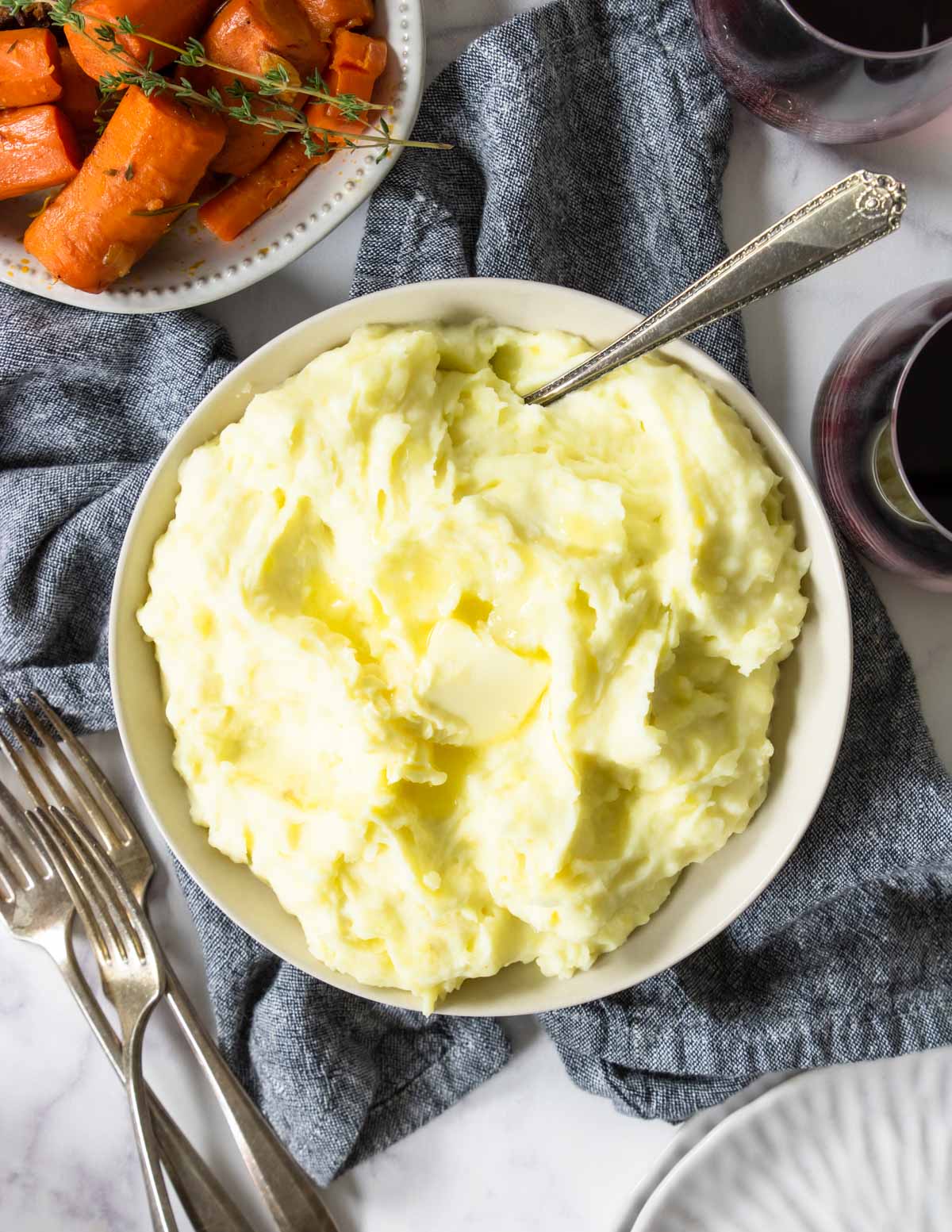 yukon gold mashed potatoes in a bowl topped with butter