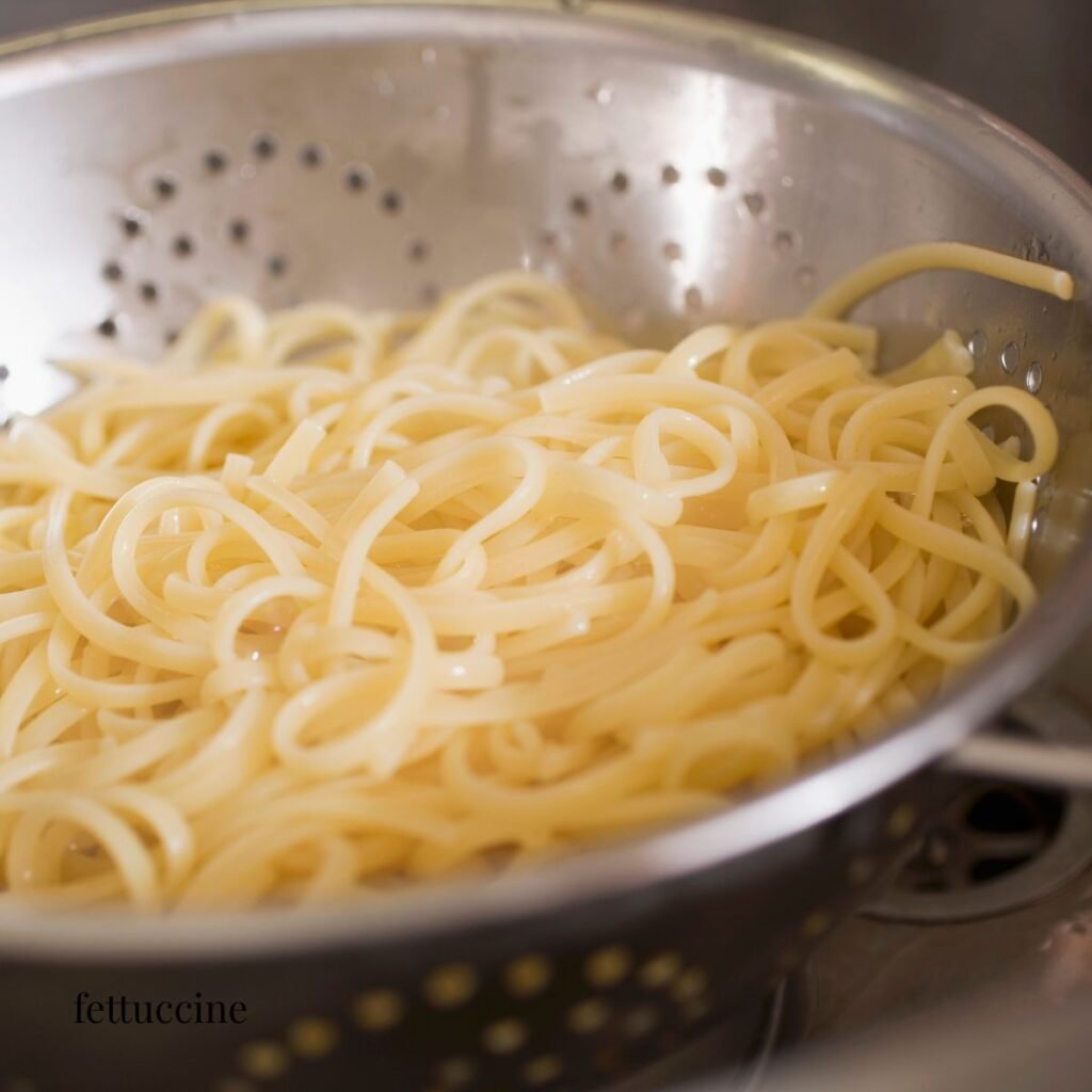 cooked fettuccine in a strainer
