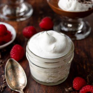 a glass jar filled with whipped cream