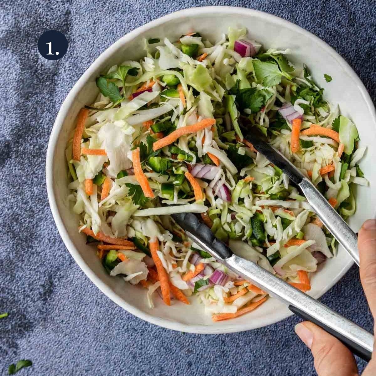 slaw being mixed in a bowl
