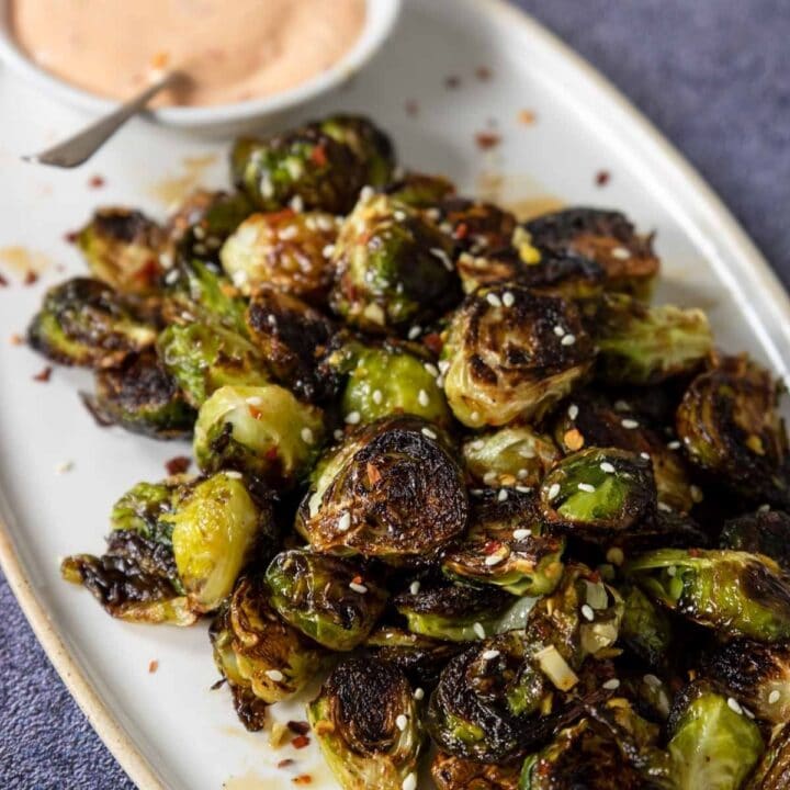 brussels sprouts on a plate with a dipping sauce
