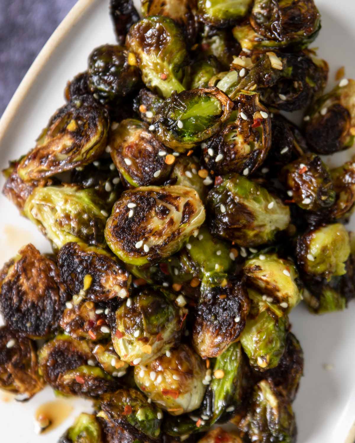 a plate with roasted brussels sprouts with sesame seeds