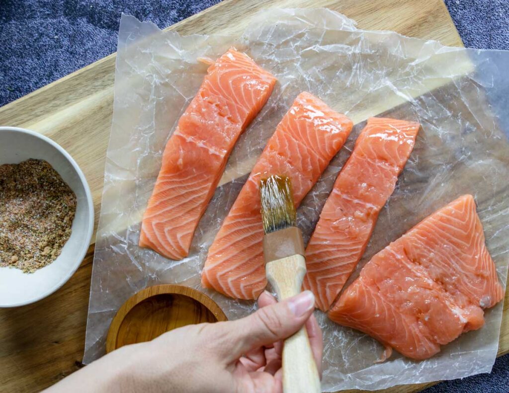 brushing salmon fillets with olive oil