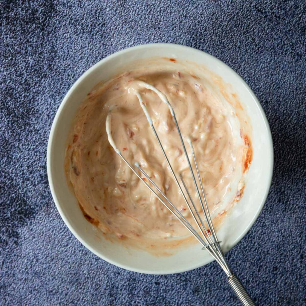 creamy ingredients whisked together in a bowl