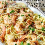 shrimp over pasta and garnished with parsley