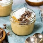 butterscotch pudding in a mason jar topped with whipped cream and chocolate