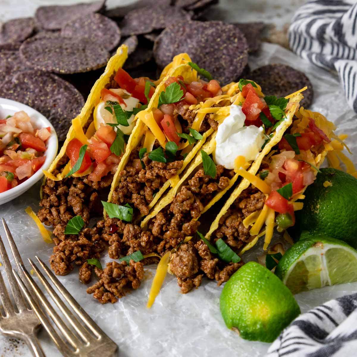 ground beef tacos with lettuce, cheese and tomatoes