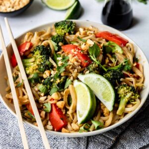 vegetable Pad Thai in a large bowl with chop sticks and limes