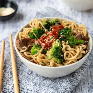 a bowl of Beef Ramen Noodles with broccoli and chili paste