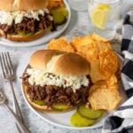 shredded bbq beef on a bun topped with coleslaw