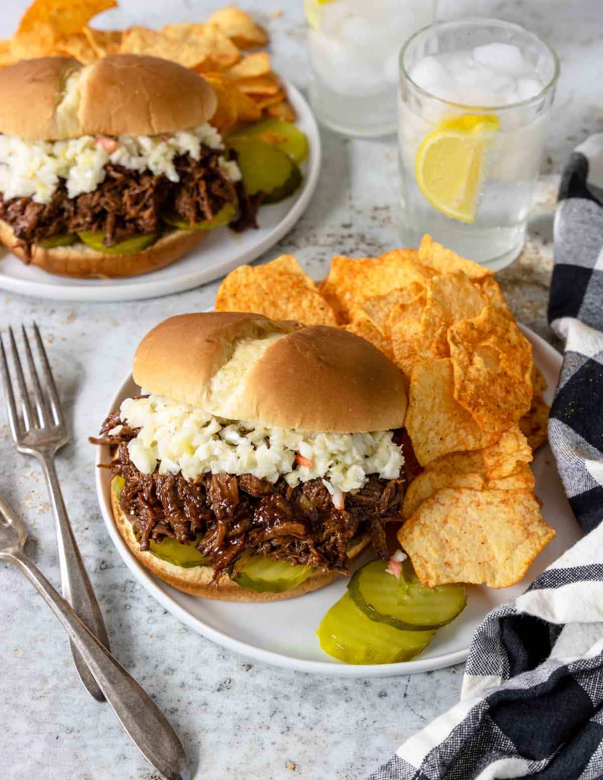 shredded bbq beef on a bun topped with coleslaw