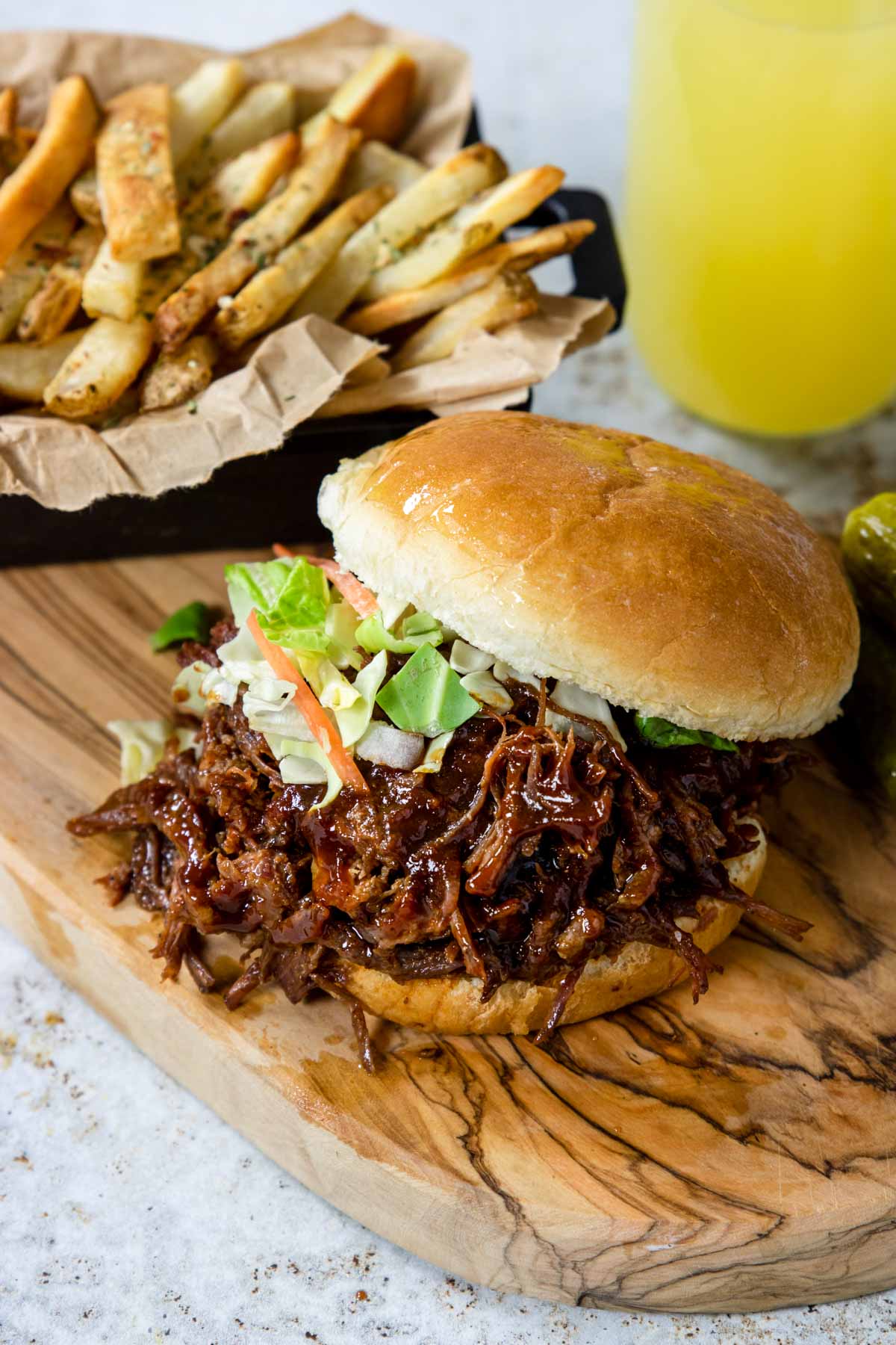 Shredded BBQ Beef Sandwich with fries and a soda