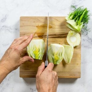 Cutting fennel in half and trimming the ends