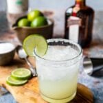 a classic margarita in a rocks glass with a salt rim and a lime wheel