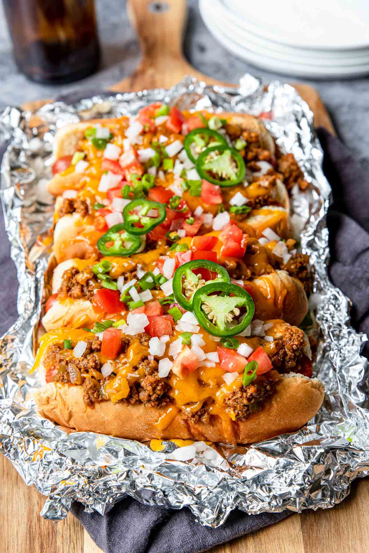 chili cheese dogs with all the toppings in a foil packet