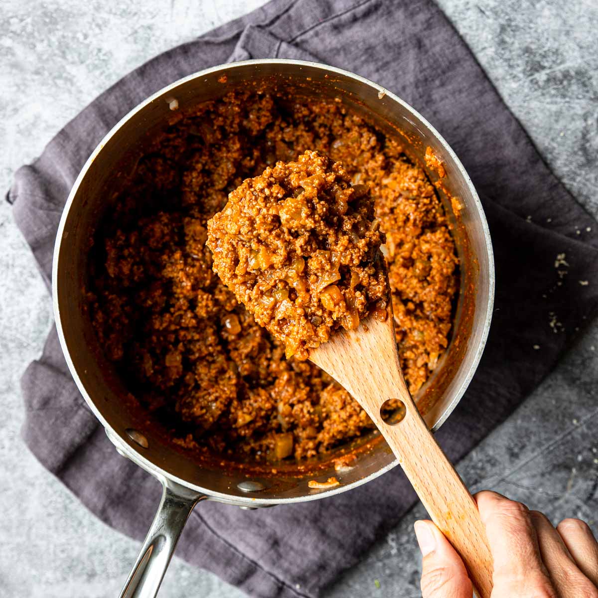 quick stove top chili in a pot and on a wooden spoon