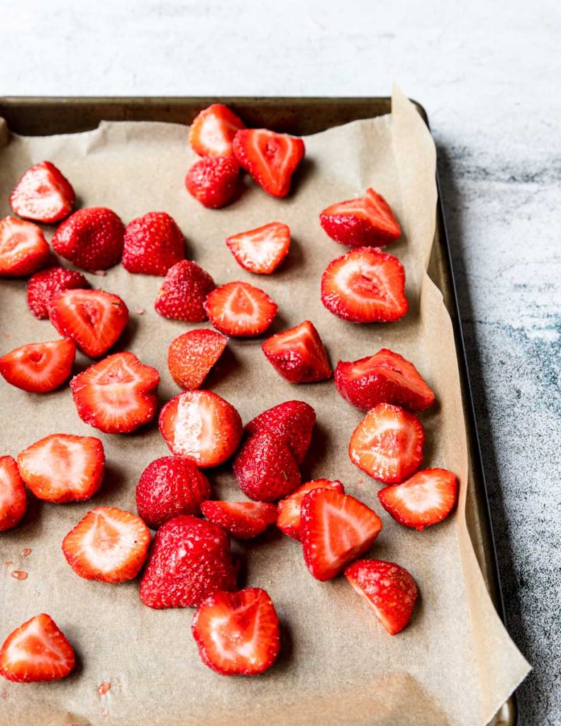 strawberries and sugar on a roasting pan
