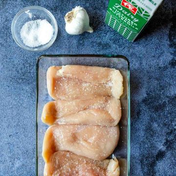 chicken salted in a glass baking dish
