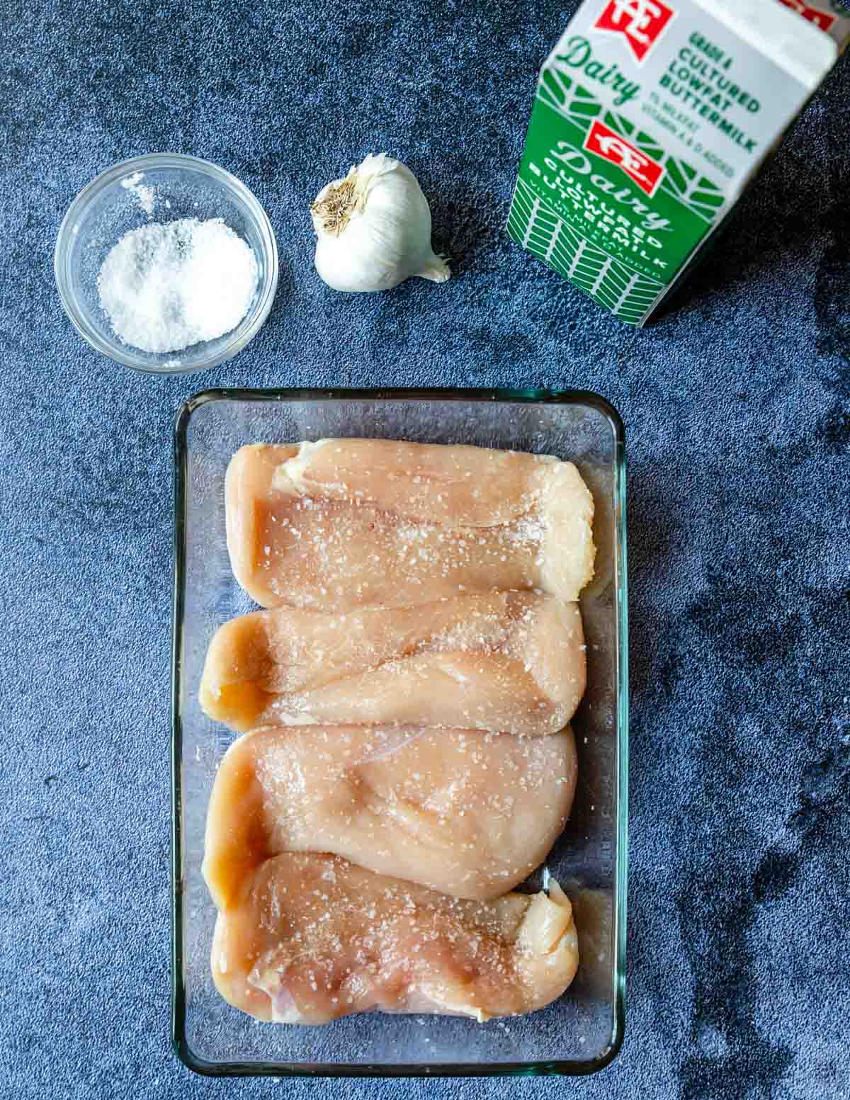 chicken salted in a glass baking dish